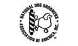 A black and white logo of the national dog groomers association.